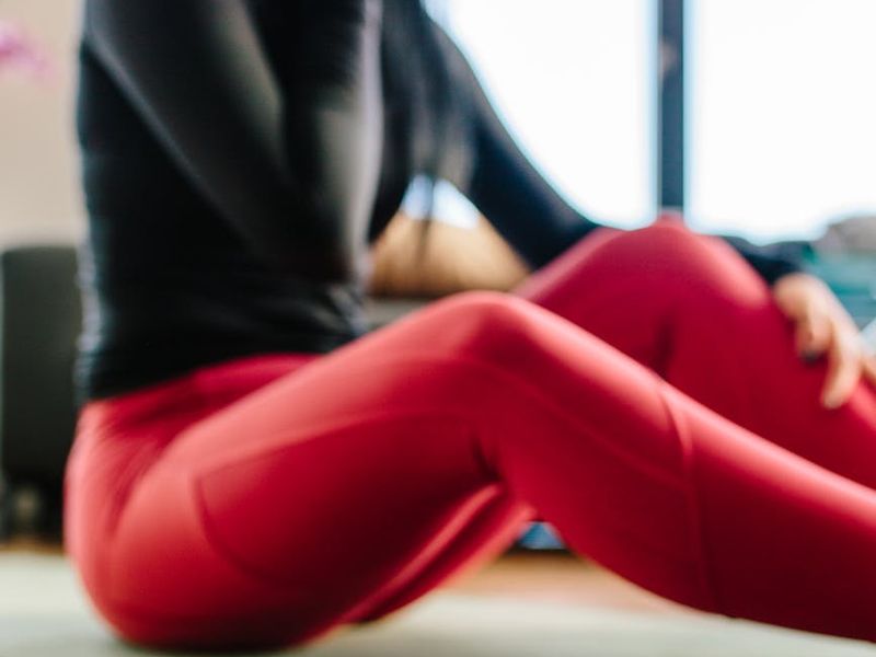 Spacious, bright room with a yoga mat on the wooden floor.